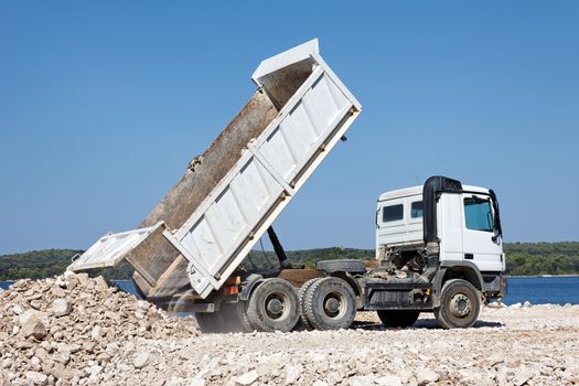 tipper truck unload crushed rocks