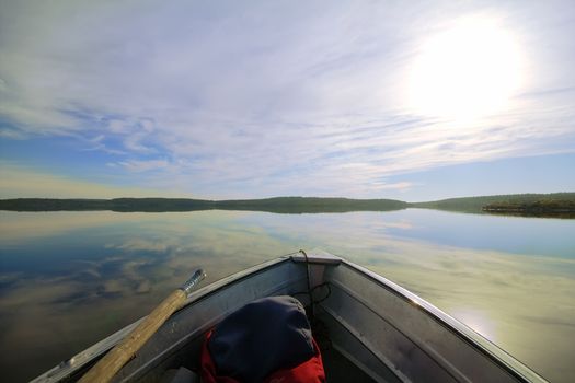 lake's calm waters on a boat with backpack