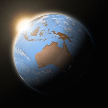 Sun over Australia on blue planet Earth isolated on black background. Highly detailed planet surface. Elements of this image furnished by NASA.