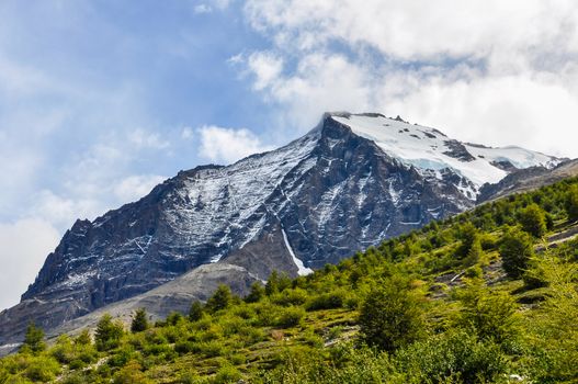 A peak covered with snow in summer in the Torres del Paine National Park, Patagonia, Chile