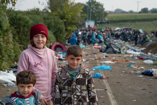 SERBIA, Berkasovo: Children stand at the ruins of a makeshift camp as Middle Eastern refugees crossed fields in the Serbian town of Berkasovo, on the border with Croatia on September 24, 2015. 