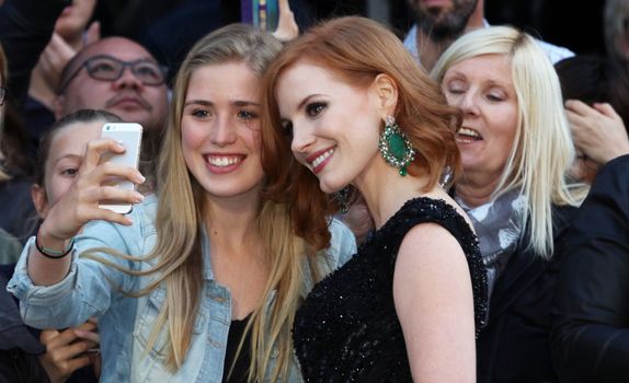 ENGLAND, London: Jessica Chastain has a selfie taken with a fan during the European premiere of The Martian in Leicester Square in London, UK on September 24, 2015