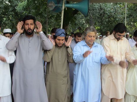 PAKISTAN, Peshawar: Muslims celebrate Eid-al-Adha by offering prayers at a mosque in Peshawar, Pakistan on September 25, 2015. The festival marks the end of Hajj, which is a holy pilgrimage that many Muslims make every year.  	