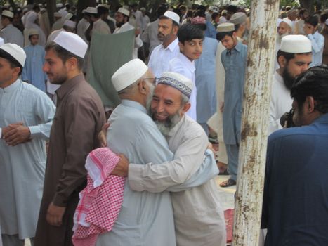 PAKISTAN, Peshawar: Muslims celebrate Eid-al-Adha by greeting each other at a mosque in Peshawar, Pakistan on September 25, 2015. The festival marks the end of Hajj, which is a holy pilgrimage that many Muslims make every year.  	