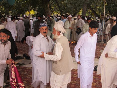 PAKISTAN, Peshawar: Muslims celebrate Eid-al-Adha by greeting each other at a mosque in Peshawar, Pakistan on September 25, 2015. The festival marks the end of Hajj, which is a holy pilgrimage that many Muslims make every year.  	