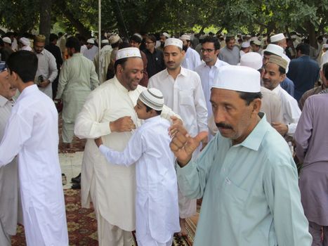 PAKISTAN, Peshawar: Muslims celebrate Eid-al-Adha by greeting each other at a mosque in Peshawar, Pakistan on September 25, 2015. The festival marks the end of Hajj, which is a holy pilgrimage that many Muslims make every year.  	