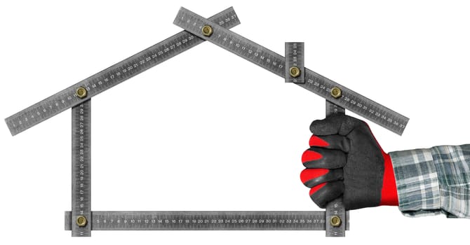 Hand with red and black work glove holding a metal meter ruler in the shape of house isolated on white background. Concept of house project 