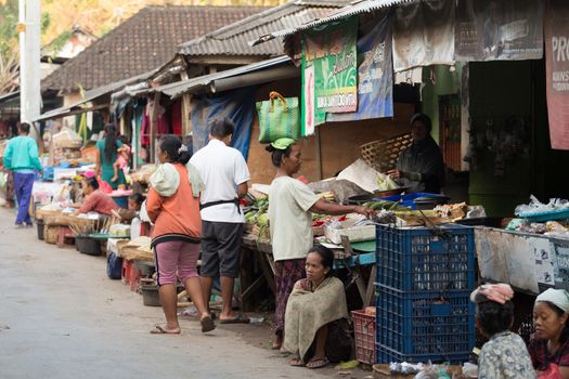 PENIDA ISLAND, INDONESIA - JUNE 30.2015: woman Hindu at the traditional daily street market, village Toyopakeh, Nusa Penida, Bali June 30. 2015 Indonesia