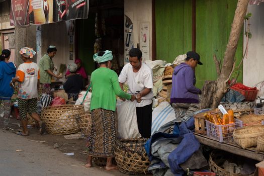 PENIDA ISLAND, INDONESIA - JUNE 30.2015: woman Hindu at the traditional daily street market, village Toyopakeh, Nusa Penida, Bali June 30. 2015 Indonesia