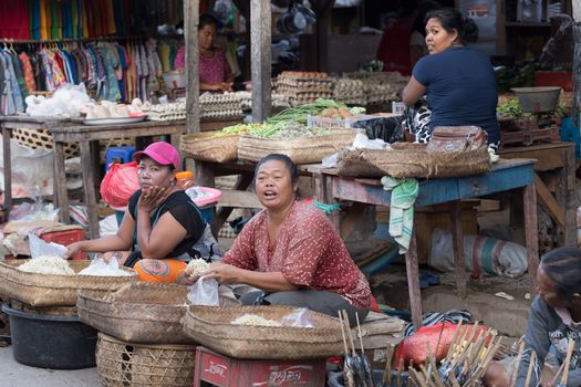 PENIDA ISLAND, INDONESIA - JUNE 30.2015: woman Hindu at the traditional daily street market, village Toyopakeh, Nusa Penida, Bali June 30. 2015 Indonesia