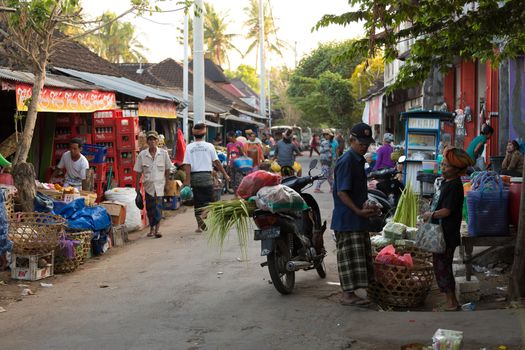 PENIDA ISLAND, INDONESIA - JUNE 30.2015: woman Hindu at the traditional daily street market, village Toyopakeh, Nusa Penida, Bali June 30. 2015 Indonesia