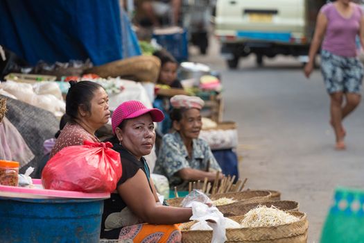 PENIDA ISLAND, INDONESIA - JUNE 30.2015: woman Hindu at the traditional daily street market, village Toyopakeh, Nusa Penida, Bali June 30. 2015 Indonesia