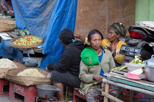 PENIDA ISLAND, INDONESIA - JUNE 30.2015: woman Hindu at the traditional daily street market, village Toyopakeh, Nusa Penida, Bali June 30. 2015 Indonesia