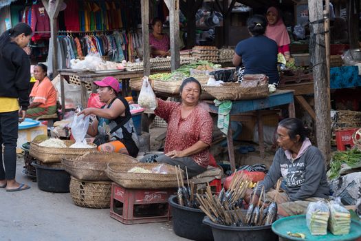 PENIDA ISLAND, INDONESIA - JUNE 30.2015: woman Hindu at the traditional daily street market, village Toyopakeh, Nusa Penida, Bali June 30. 2015 Indonesia