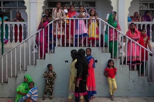 NEPAL, Kathmandu: Young Muslim women stand and watch Eid-al-Adha celebrations at a Kasmere Jama mosque in Kathmandu, Nepal on September 25, 2015. The festival marks the end of Hajj, which is a holy pilgrimage that many Muslims make every year. People of Islamic faith have felt more comfortable celebrating Eid ul-Adha in Nepal after the country ushered in a new democratic, secularist constitution