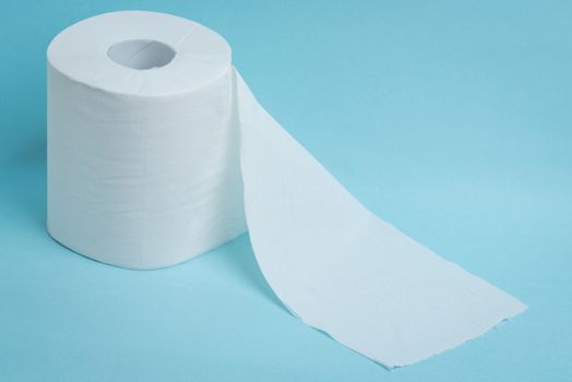 A new roll of toilet paper on a blue background.