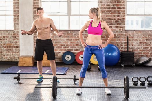 Two fit people working out in crossfit gym