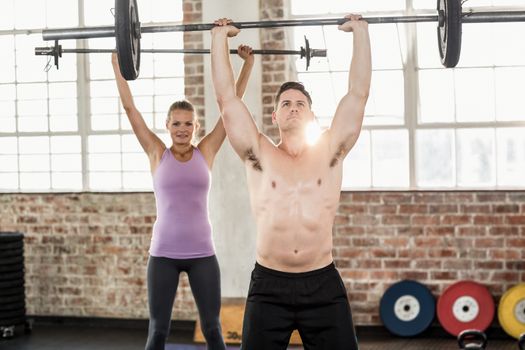 Two fit people working out at crossfit session 