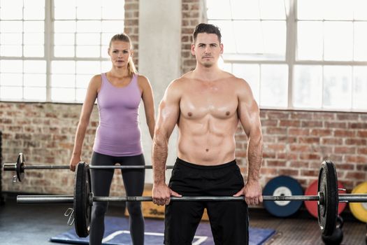 Two fit people working out at crossfit session 