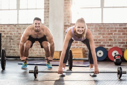 Two fit people working out at crossfit session 