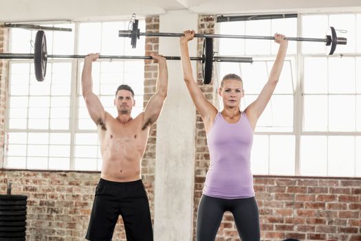 Two fit people working out at crossfit session 