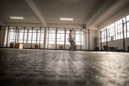 Two fit people doing fitness in crossfit gym