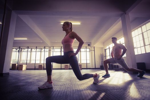 Two fit people doing fitness in crossfit gym