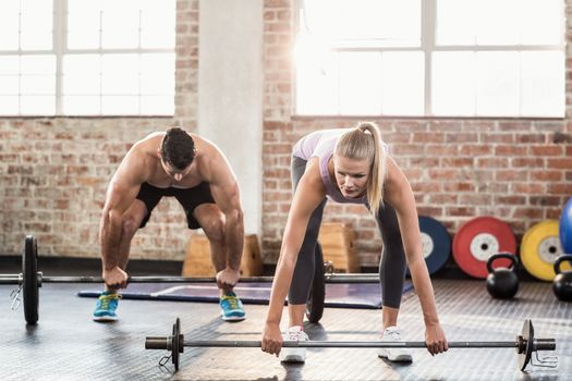 Two fit people working out at crossfit session 