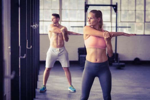 two fit people doing fitness in crossfit gym
