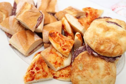 plate of sandwiches with corpses, buns and pizza