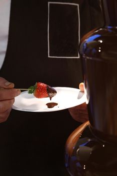 strawberries with melted chocolate on plate