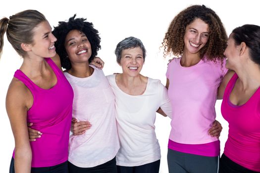 Smiling women with arms around while standing against white background