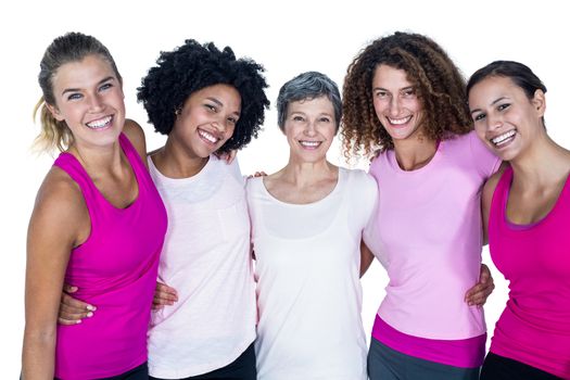 Portrait of smiling women with arms around while standing against white background