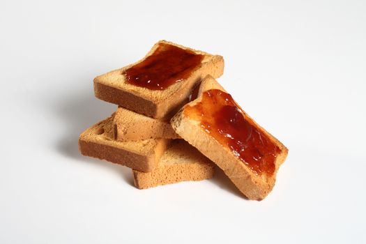 group of five biscuits with jam on a white background