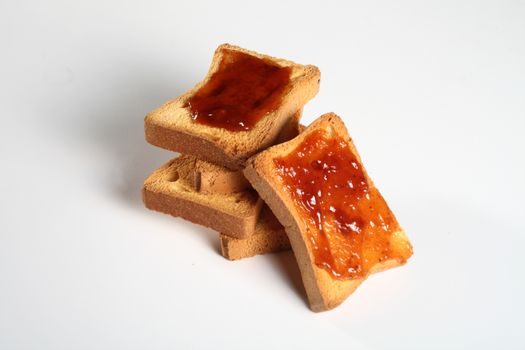 group of five biscuits with jam on a white background