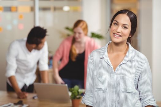 Portrait of confident woman smiling at office 