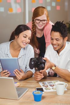 Happy business people with camera in working office