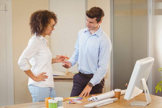 Business people standing by table in office