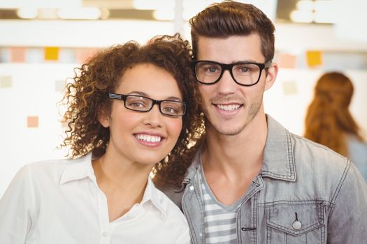 Portrait of smiling business people wearing eyeglasses in creative office