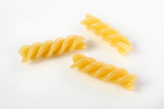 fusilli on white background