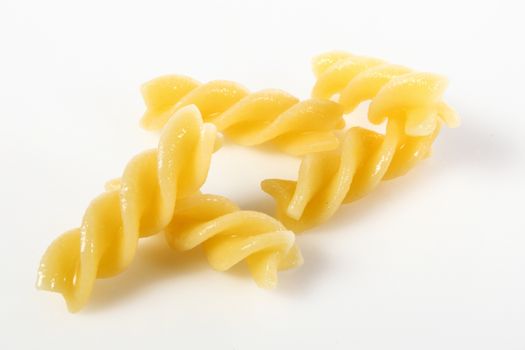 fusilli on white background