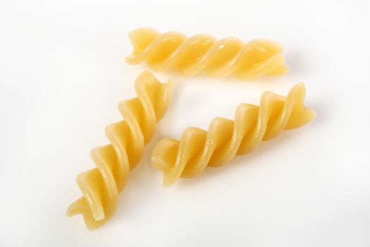 fusilli on white background