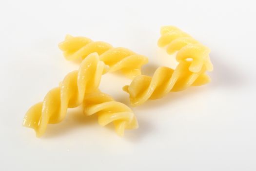 fusilli on white background