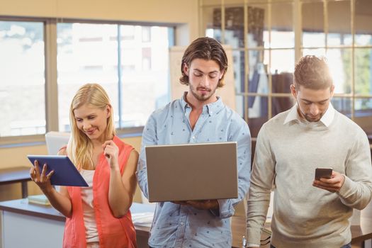 Employees using technologies in creative office