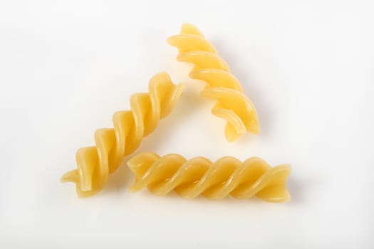 fusilli on white background