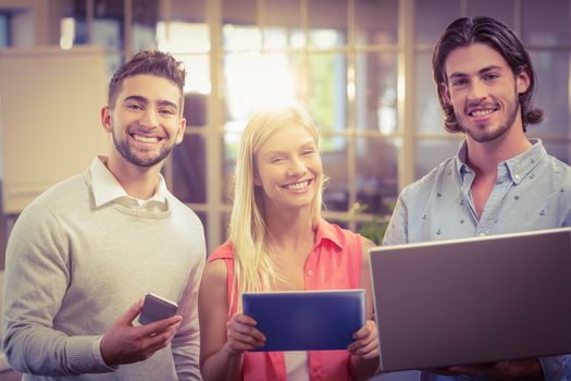 Portrait of confident business people working with the help of technologies in creative office