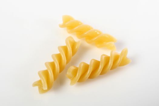 fusilli on white background