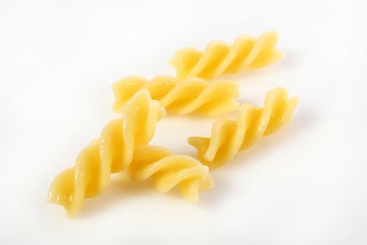 fusilli on white background