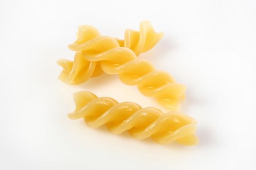 fusilli on white background