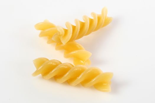 fusilli on white background